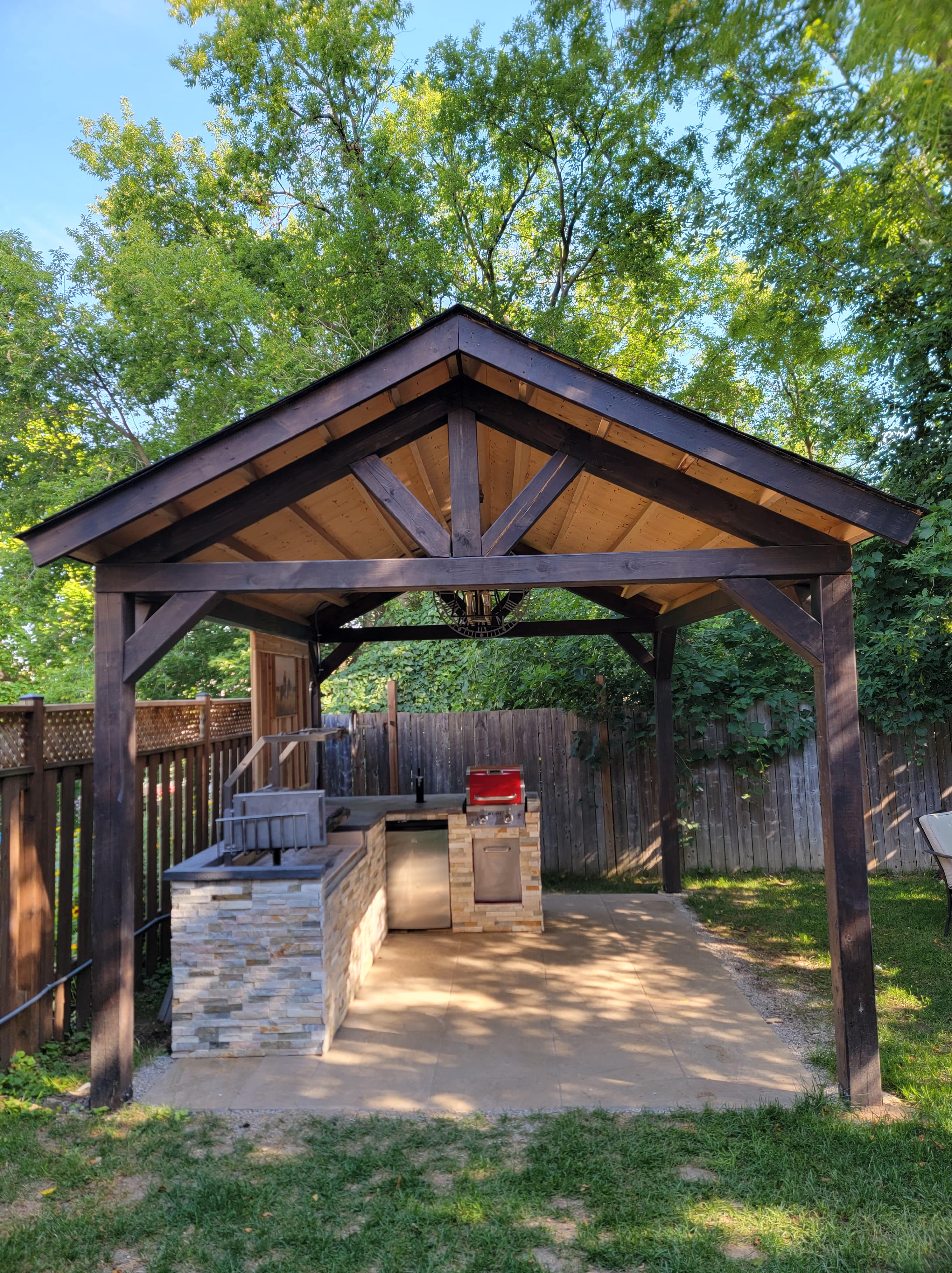 Luxury outdoor kitchen with built-in grill and seating area