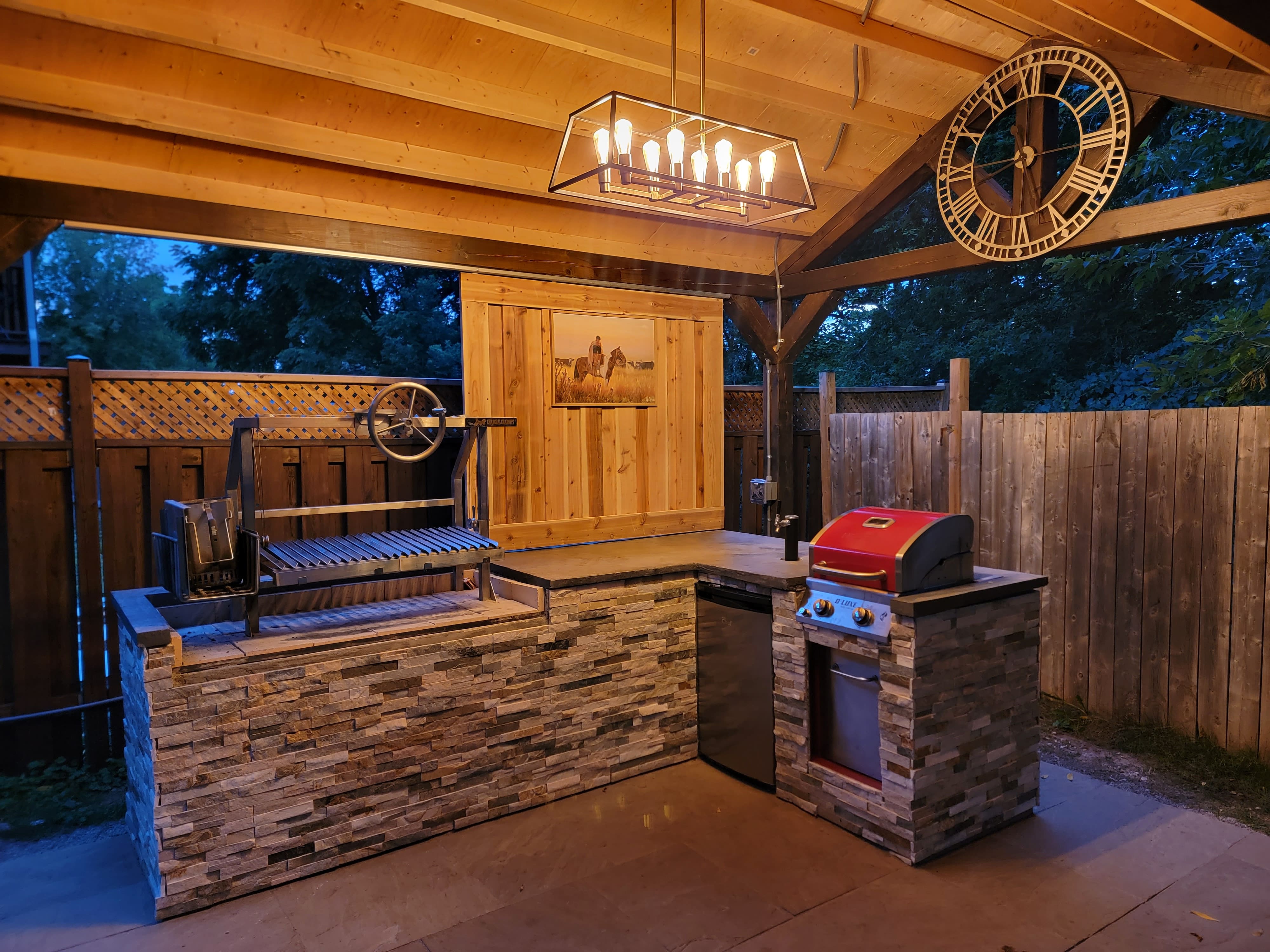 Elegant outdoor kitchen with bar seating and ambient lighting